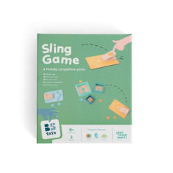 Caixa verda de Sling Game amb il·lustracions de taulers de fusta i fitxes circulars per a jocs de punteria.